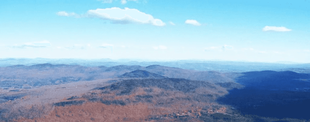 Expansive mountain landscape under a clear blue sky.