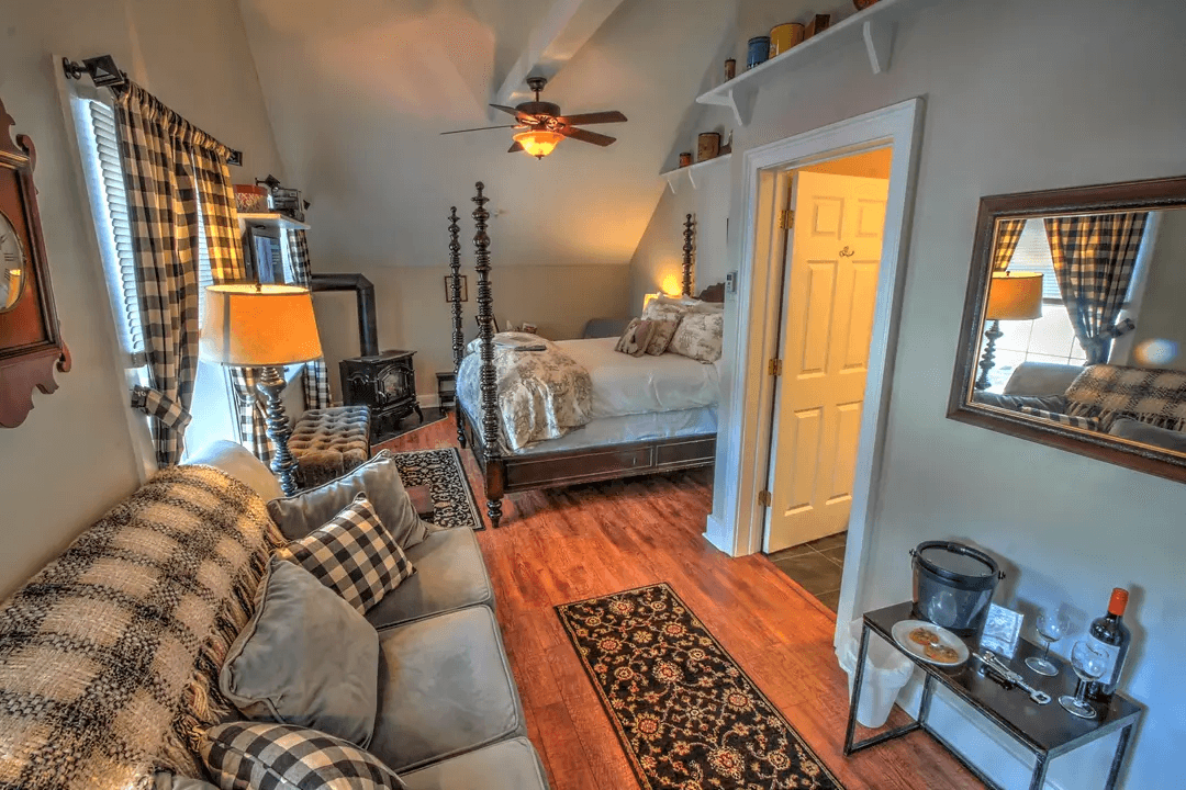 Cozy room featuring a bed, seating area, and modern decor.